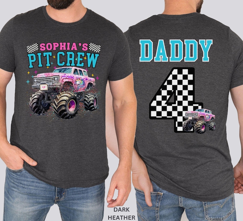 May include: Dark heather gray t-shirt with a monster truck graphic. The front of the shirt says "Sophia's Pit Crew" above a pink monster truck with a unicorn design. The back says "Daddy" above a checkered number 4.