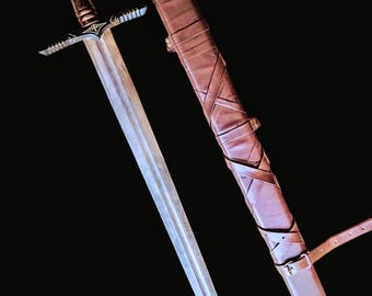 May include: A silver sword with a brown leather scabbard. The sword has a decorative hilt with a star-shaped design. The scabbard has a strap and buckle.