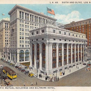 May include: Vintage postcard depicting the Pacific Mutual Buildings and Biltmore Hotel in Los Angeles, California. The image shows several tall buildings, American flags, vintage cars, and streetcars. The postcard is labeled "L.A. 48. Sixth and Olive, Los Angeles, Calif."