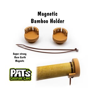 May include: A magnetic bamboo holder set with two brown holders, a brown tie, and a bamboo tube. The text "Magnetic Bamboo Holder" is displayed above the holders. The text "Super strong Rare Earth Magnets" is also visible.