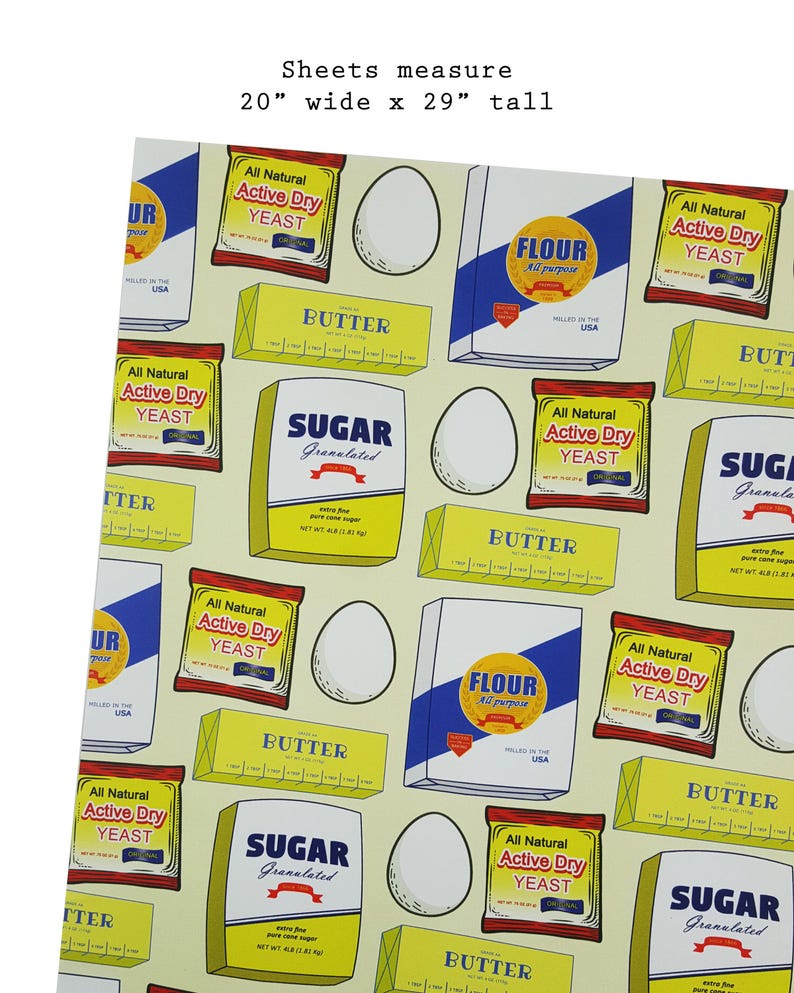Puede incluir: Un papel de envolver estampado en amarillo y blanco con im&aacute;genes de ingredientes para hornear, incluyendo harina, az&uacute;car, mantequilla, levadura y huevos. El papel mide 51 cm de ancho por 74 cm de alto.