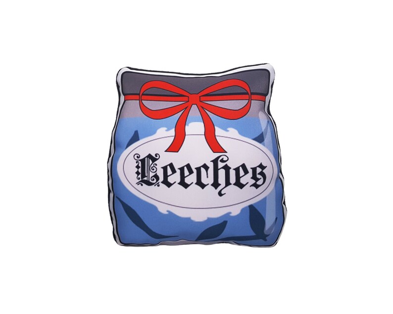 May include: A blue and white pillow shaped like a jar with a red bow and the word "Leeeches" written on the label.