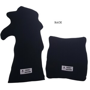 May include: Two black fabric cushions with a white logo that says "Firebolt Creations" and a small graphic of a top hat with crossed swords. The back of one cushion is shown.