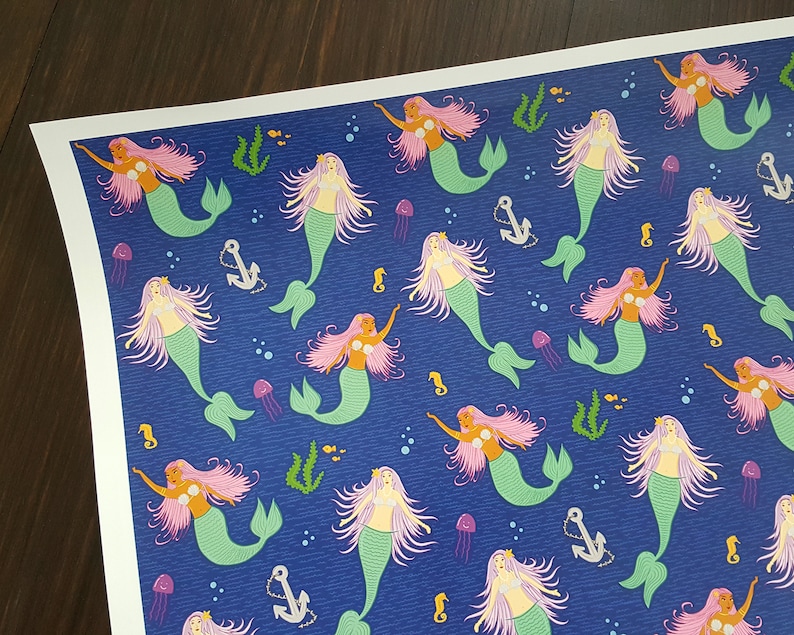 May include: A blue background with a repeating pattern of mermaids with pink hair and green tails. The mermaids are swimming in a sea of blue with white bubbles and seahorses.