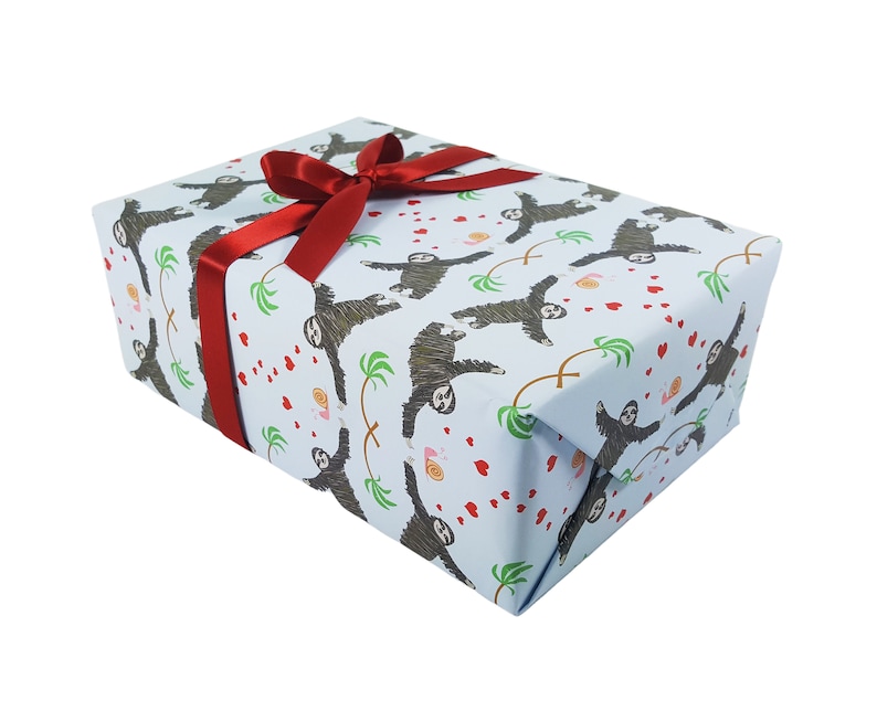 May include: A light blue gift wrap with a pattern of sloths holding hearts and palm trees. A red ribbon is tied around the box.
