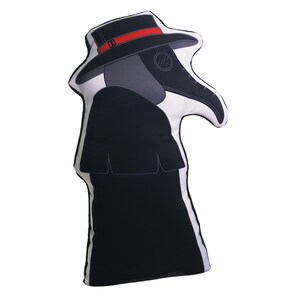 May include: A black and white pillow shaped like a plague doctor wearing a black hat with a red band and a long black coat.