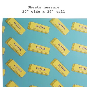 May include: A sheet of paper with a repeating pattern of yellow butter sticks on a teal background. The text "BUTTER" is printed on each butter stick. The sheets measure 20 inches wide by 29 inches tall.