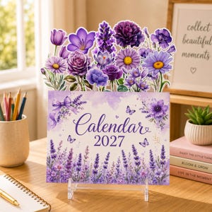 May include: A 2027 calendar featuring a purple floral theme with lavender, roses, and daisies. The top edge is die-cut in the shape of various purple flowers. The calendar displays the text Calendar 2027 with lavender illustrations and butterflies.