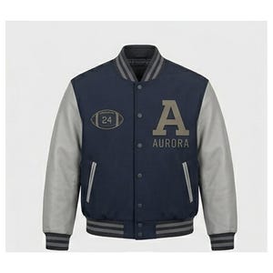 May include: A navy blue varsity jacket with gray sleeves. The jacket features the letter "A" and the word "AURORA" in gray on the front. An oval patch with the number "24" is also visible. The jacket has a ribbed collar, cuffs, and hem.