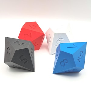 May include: Four multi-sided dice in red, white, blue, and grey. Each die has a different number of sides and is marked with large, easy-to-read numbers. The dice are set against a white background.