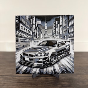 May include: A black and white illustration of a silver sports car driving through a city street in Japan. The car is a Nissan Skyline GT-R R34. The background features a cityscape with buildings and the Tokyo Tower.