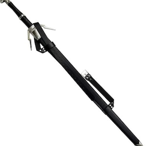 May include: A long, black sword with a silver hilt and a black leather sheath. The sword has a pointed tip and is angled diagonally across the frame. The hilt features a detailed design, and the sheath has a belt for carrying.