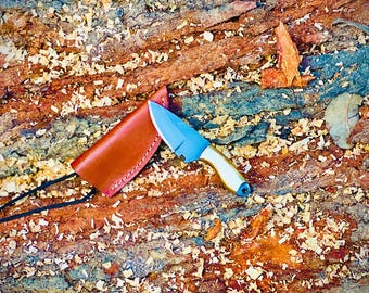 Handgjord kniv i rostfritt stål med full tånge, mässingshandtag och hals, flåkniv med läderslida