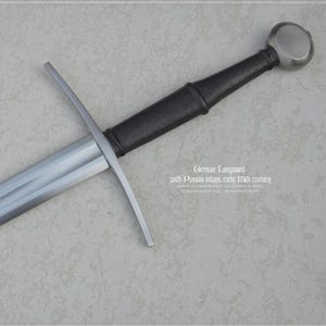 May include: A German longsword with a silver-toned steel blade, a straight crossguard, a black leather-wrapped grip, and a rounded pommel. The blade features text reading German Longsword with Passau inlay, early 15th century.