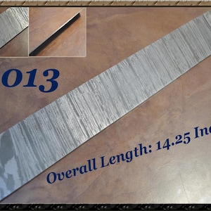 May include: A rectangular metal bar with a textured, silver-gray surface. The overall length is 14.25 inches. The number "6013" is printed in blue. Two smaller inset images show details of the bar.