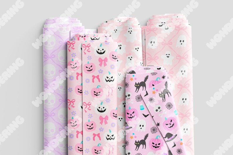 May include: Four different pink and white patterned wrapping paper designs. One design features a skull and crossbones, another features a ghost, another features a pumpkin, and the last features a black cat and spider web.
