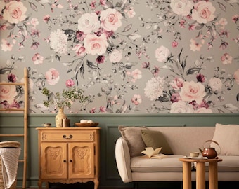 May include: A living room scene featuring a floral wallpaper with pink roses and gray foliage. A wooden cabinet, a beige sofa, and a small wooden table are in the foreground. A decorative ladder and a woven basket add to the room's aesthetic.