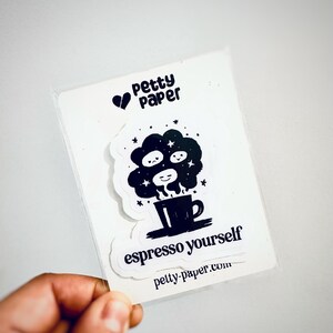 May include: A clear plastic sleeve holding two stickers. The top sticker has the text "Petty Paper" with a heart symbol. The bottom sticker says "espresso yourself" with a coffee cup design. The website petty-paper.com is also visible.