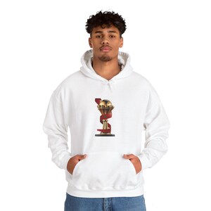 May include: White hooded sweatshirt with a gold trophy with a red ribbon on it.