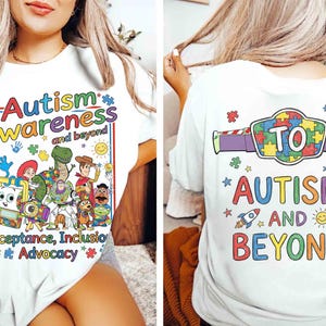 May include: White t-shirt with a colorful graphic promoting autism awareness. The front features the words "Autism Awareness and beyond" with cartoon characters. The back of the shirt says "TO AUTISM AND BEYOND" with a puzzle piece design.