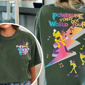 May include: A green t-shirt with a cartoon image of Goofy and his friends. The back of the shirt has a graphic of a cartoon character standing on a lightning bolt with the text "Powerline Stand Out World Tour".