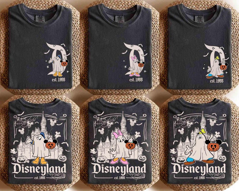 May include: Six dark grey t-shirts with Halloween-themed Disney designs. The shirts feature Mickey and Minnie Mouse dressed as ghosts, holding pumpkins. Some shirts have the Disneyland logo and the text "est. 1955".