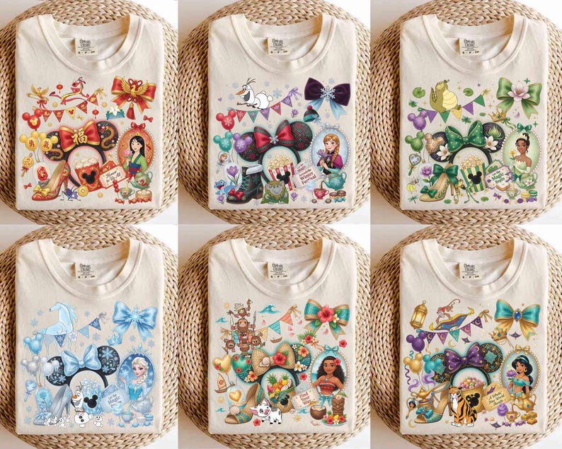 May include: Cream-colored t-shirts with colorful graphic designs featuring cartoon characters, bows, and decorative elements. Each shirt showcases a different character theme, with detailed illustrations and vibrant colors.