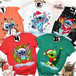 May include: A collection of five short-sleeved t-shirts featuring holiday-themed cartoon character designs. The shirts are in various colors, including orange, white, black, red, and green. Each shirt showcases a different festive graphic, such as a character in a Santa hat or with a Christmas tree.