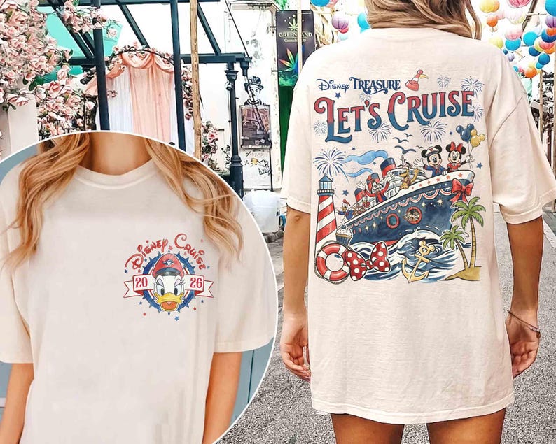 May include: A cream-colored t-shirt featuring a small graphic of Donald Duck on the front left chest with the text Disney Cruise 2026. The back displays a large illustration of a cruise ship, Mickey and Minnie Mouse, a lighthouse, and Let's Cruise.