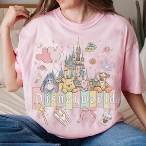 May include: A white ceramic mug with a black handle and the text "But First, Coffee" in a black, handwritten-style font. The mug is on a white surface.