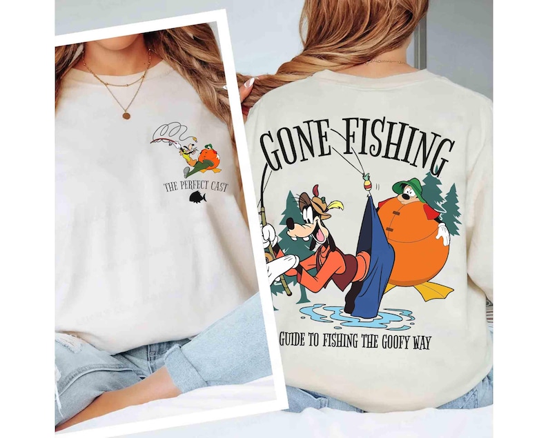 May include: Off-white sweatshirt featuring a cartoon design of Goofy fishing. The front of the shirt has the text "The Perfect Cast" and a small fish graphic. The back of the shirt says "Gone Fishing" and "Guide to Fishing the Goofy Way".