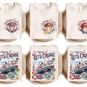 May include: Off-white t-shirts featuring Disney Cruise 2026 graphics with character portraits on the chest and a large Disney Treasure Let's Cruise design on the back, including a cruise ship, lighthouse, palm trees, and Mickey and Minnie Mouse.