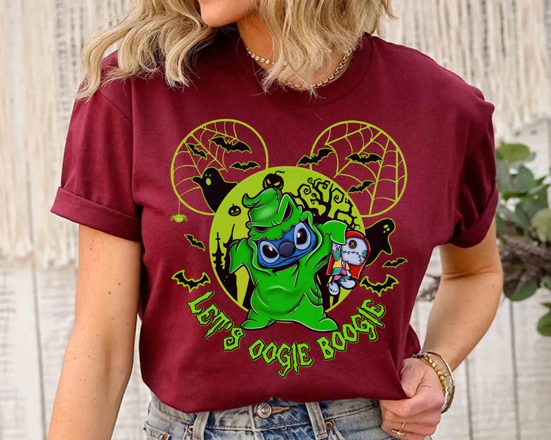 May include: Burgundy t-shirt featuring a green Oogie Boogie-inspired Stitch character holding a rag doll. The design includes bats, spiderwebs, and the text "Let's Oogie Boogie" in green, with a Mickey Mouse ear silhouette.