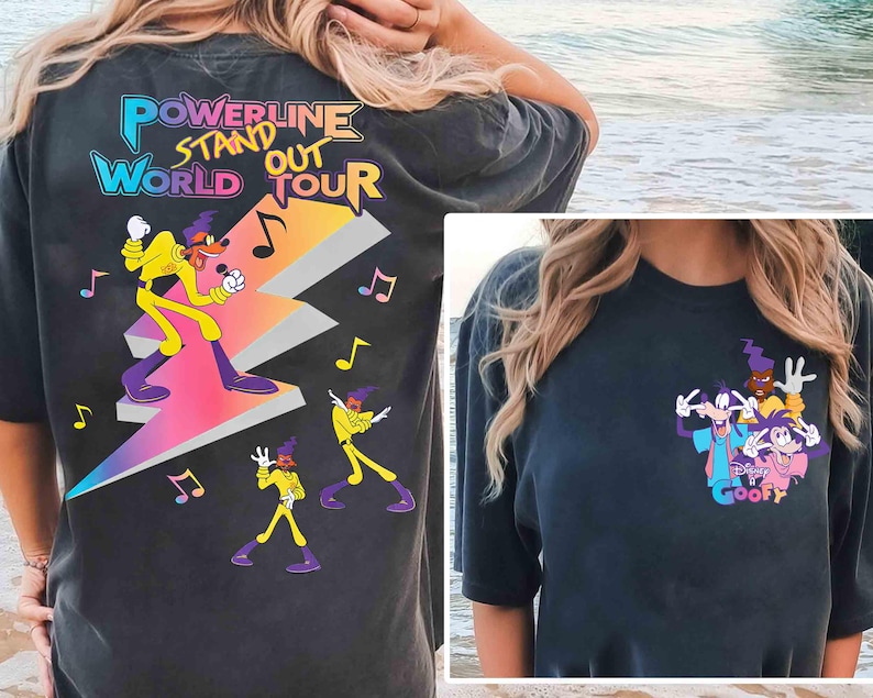 May include: Two black t-shirts with different cartoon character designs. The first shirt features a cartoon character in a purple and yellow outfit standing on a lightning bolt with the text "Powerline Stand Out World Tour". The second shirt features a group of cartoon characters with the text "Goofy".