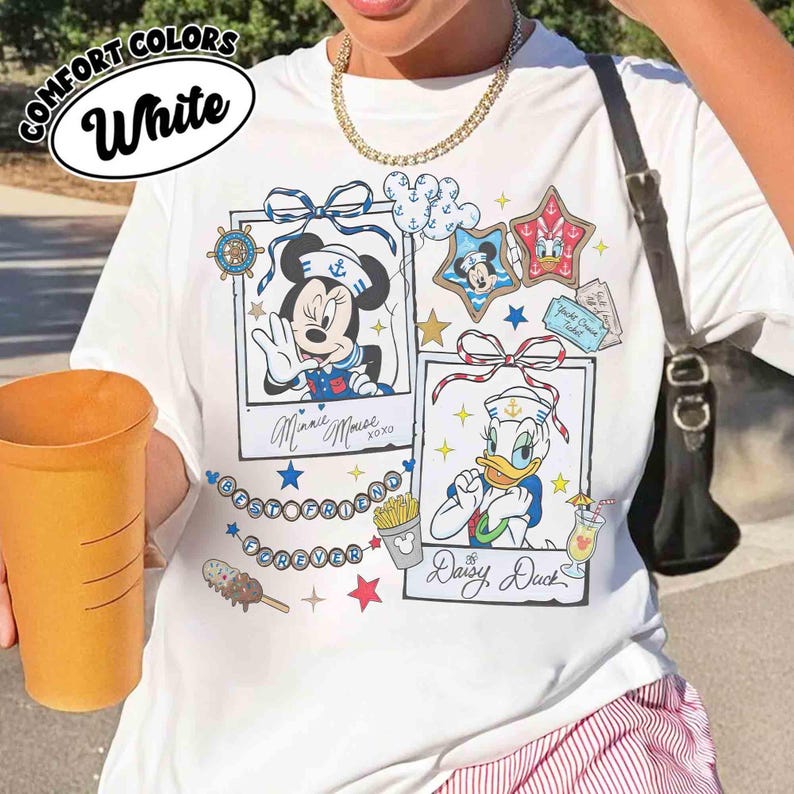 May include: White t-shirt with a graphic featuring Minnie Mouse and Daisy Duck in sailor outfits. The shirt includes the text "BESTFRIEND FOREVER" and "Minnie Mouse" and "Daisy Duck" in cursive.