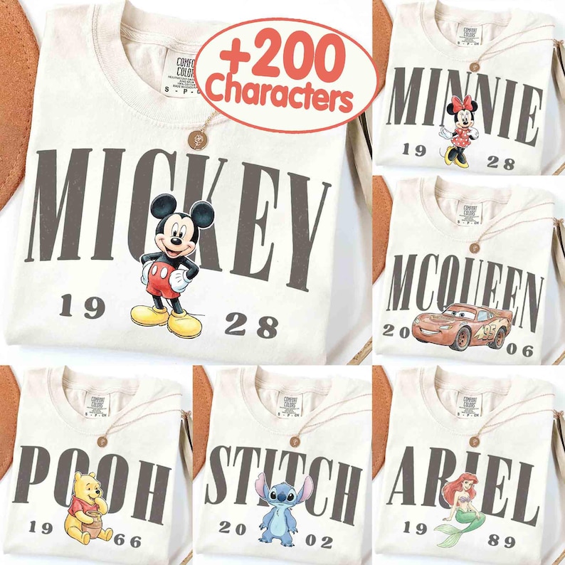 May include: Cream-colored t-shirts featuring various Disney characters: Mickey Mouse, Minnie Mouse, Lightning McQueen, Winnie the Pooh, Stitch, and Ariel. Each shirt has the character's name and a year printed on it.
