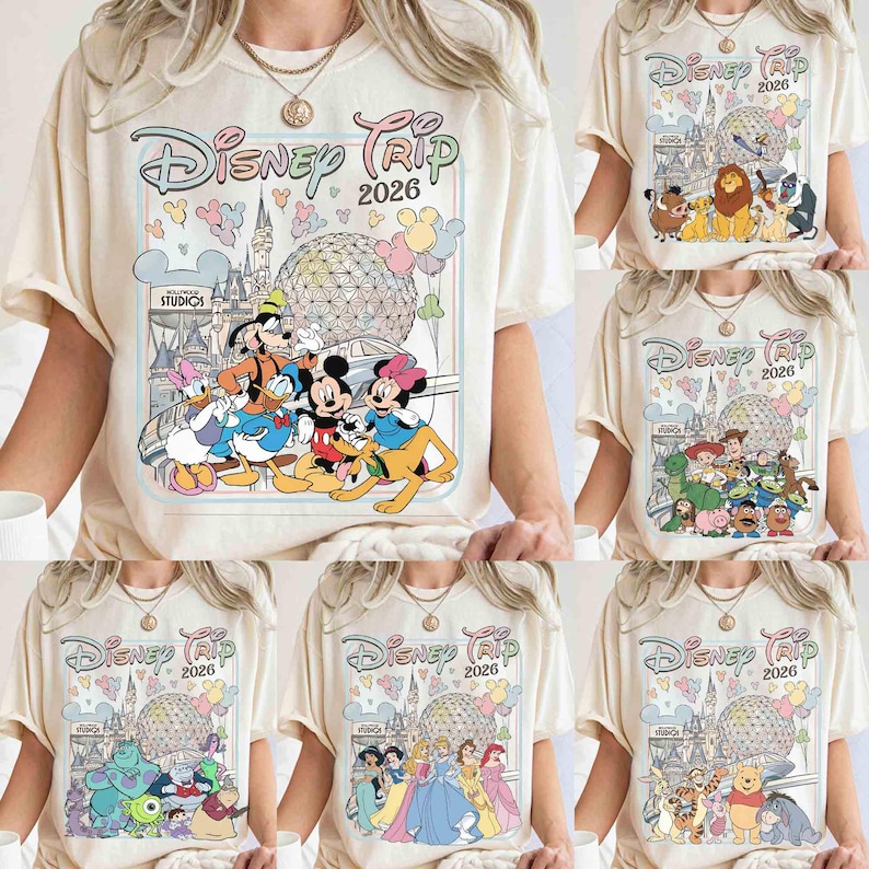 May include: Cream-colored t-shirts with various Disney character graphics. Each shirt features the text "Disney Trip 2026" in a whimsical font, along with iconic Disney imagery like Mickey Mouse, princesses, and other characters.