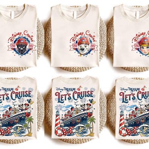 May include: Six off-white t-shirts featuring Disney Cruise 2026 graphics. The top row shows small chest prints with character heads in captain hats. The bottom row displays large prints of a cruise ship, fireworks, and Disney characters.