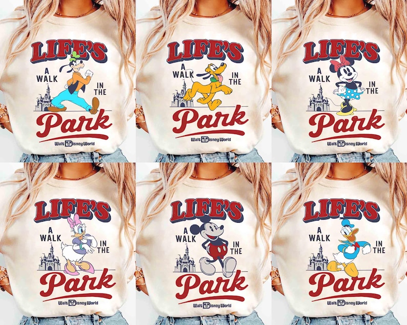 May include: Cream-colored sweatshirts featuring various Disney characters like Goofy, Pluto, Minnie Mouse, Daisy Duck, Mickey Mouse, and Donald Duck. Each shirt has the text "Life's a Walk in the Park" with the Walt Disney World logo.