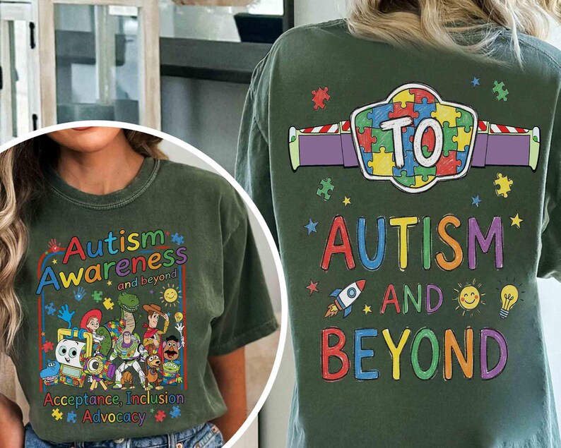 May include: Olive green t-shirt with the words "Autism Awareness and beyond" in colorful letters. The front features cartoon characters and the words "Acceptance, Inclusion, Advocacy". The back says "Autism and Beyond" with a puzzle piece design.