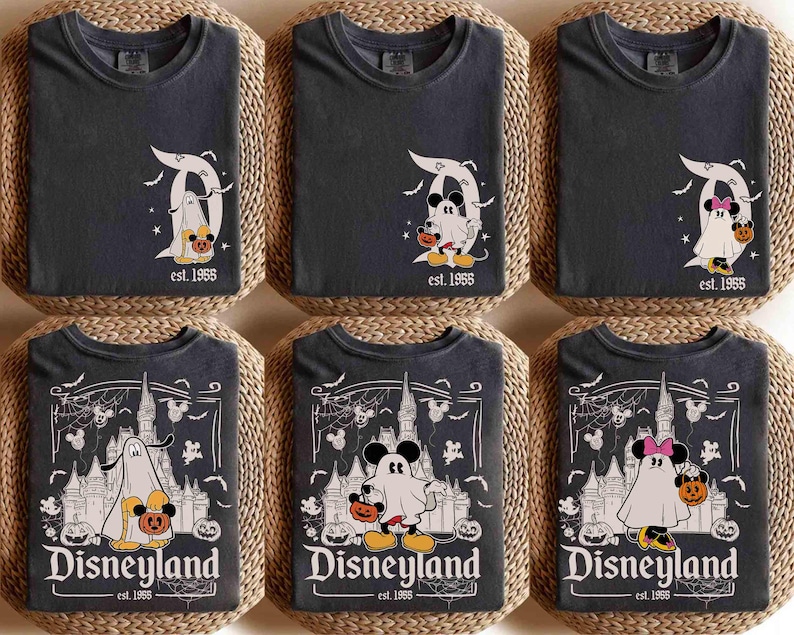 May include: Six dark grey t-shirts featuring Halloween-themed Disneyland designs. The graphics include Mickey and Minnie Mouse as ghosts, holding pumpkins, and the Disneyland logo. The text "est. 1955" is also visible.