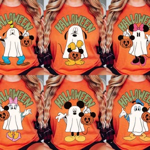 May include: Orange Halloween t-shirts featuring cartoon characters dressed as ghosts, each holding a jack-o'-lantern. The word "HALLOWEEN" is printed above the characters in green. Characters include Mickey Mouse, Minnie Mouse, Donald Duck, and Goofy.
