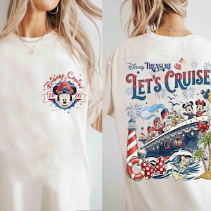 May include: A cream-colored t-shirt featuring a small Minnie Mouse graphic on the front chest with the text Disney Cruise 2026. The back displays a large illustration of a cruise ship with Disney characters, a lighthouse, and Let's Cruise text.