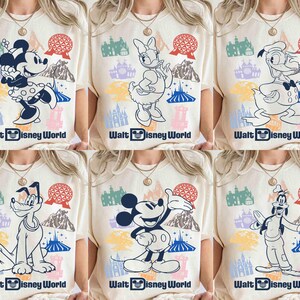 May include: Cream-colored t-shirts featuring various Disney characters, including Mickey Mouse, Minnie Mouse, Daisy Duck, Donald Duck, Pluto, and Goofy. Each shirt has a colorful graphic of the character, the text "Walt Disney World", and other park icons.