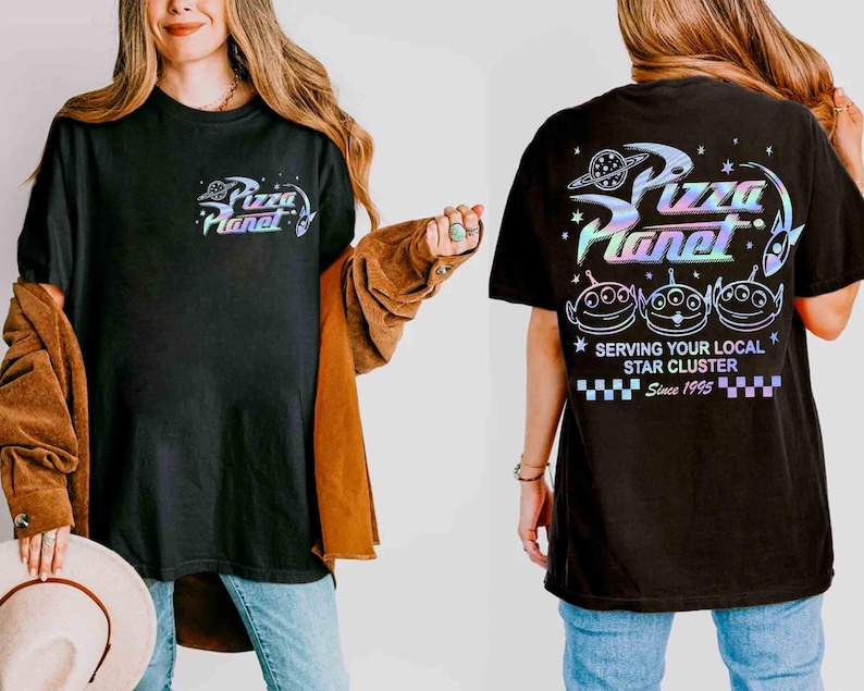 May include: Black t-shirt with a colorful "Pizza Planet" logo and alien graphic. The shirt features the text "Serving Your Local Star Cluster Since 1995" on the back. A fun, casual tee.