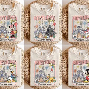 May include: Cream-colored t-shirts with birthday-themed graphics. Designs include "Birthday Girl" and "Birthday Boy" with Disney characters like Minnie Mouse, Darth Vader, Daisy Duck, Donald Duck, Pluto, and Mickey Mouse. Each design includes a castle and space for a custom name.