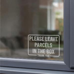 May include: A white rectangular vinyl decal applied to a glass window. The decal features a rounded border and the white text reads: PLEASE LEAVE PARCELS IN THE BOX THANK YOU. The design is clear, legible, and oriented for exterior viewing.