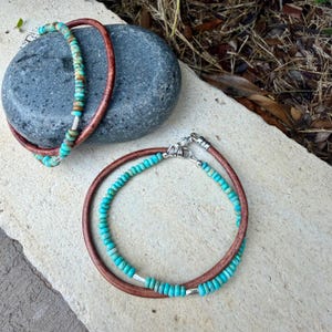 May include: Two bracelets featuring brown leather cords paired with strands of small, round, turquoise-colored beads. Each bracelet includes silver-toned metal accents and a silver-toned lobster claw clasp closure to secure the ends together.