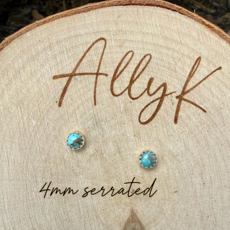 May include: Two small turquoise stud earrings with a serrated edge, each 4mm in diameter, are displayed on a wooden surface. The word "Allyk" is written in a cursive font above the earrings, and the text "4mm serrated" is below.
