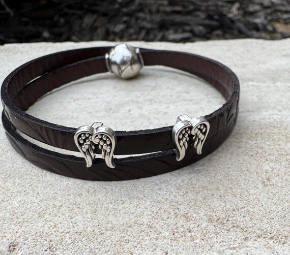 Embossed flower pattern leather wrap bracelet with angel wings spacers and magnet closure, black or dark brown leather
